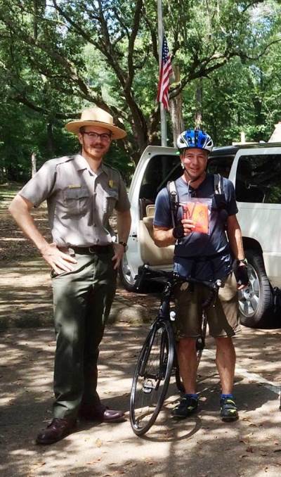 Park Ranger Jake Dinkelaker with bicyclist at the Mount Locust Visitor Center in Natchez, Mississippi.